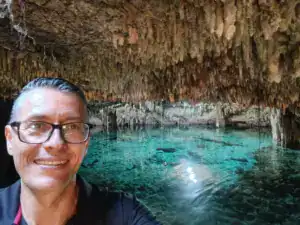 Exploring a stunning cenote near Tulum with clear turquoise waters.