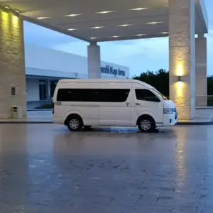 Luxury hotel entrance with white van in Riviera Maya, Mexico.
